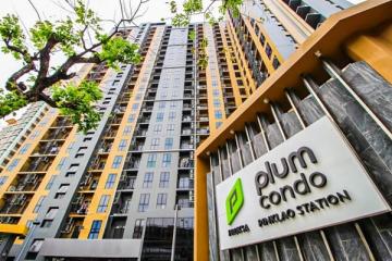 Modern high-rise condominium building exterior with signage