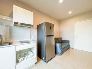 Modern kitchen with stainless steel appliances and comfortable sofa