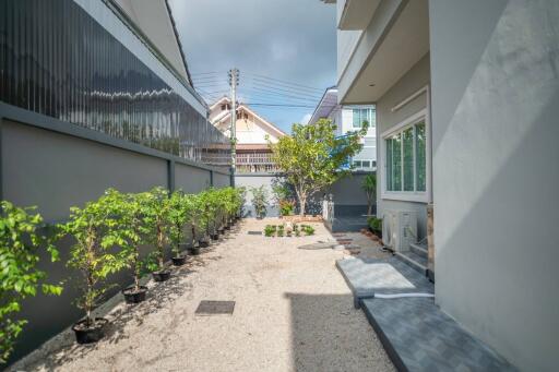 Spacious and well-maintained outdoor area of a residential property with pathway and greenery