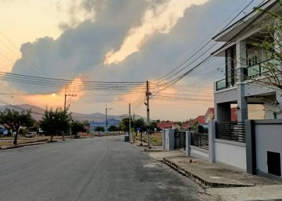 Sunset view of a residential street with modern houses