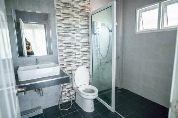 Modern bathroom with glass shower enclosure and stylish tiles