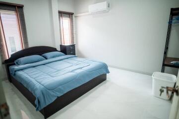 Spacious and well-lit bedroom with a large bed and modern amenities