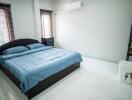 Spacious and well-lit bedroom with a large bed and modern amenities