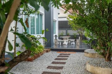 Cozy backyard patio with dining area and lush greenery