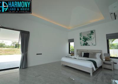 Spacious modern bedroom with natural lighting and stylish decor