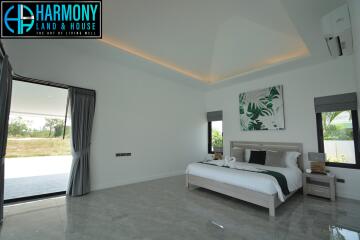 Spacious modern bedroom with natural lighting and stylish decor