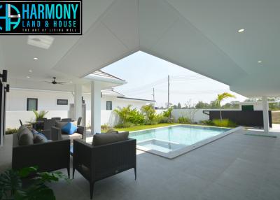 Modern patio with swimming pool and outdoor seating area