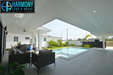 Modern patio with swimming pool and outdoor seating area