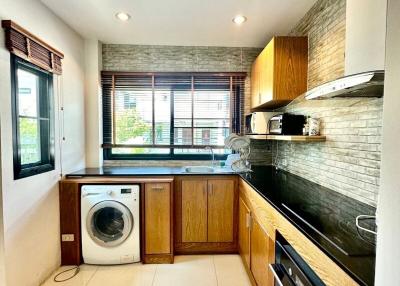 Modern kitchen with wooden cabinets and stainless steel appliances