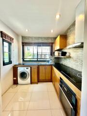 Modern kitchen with wooden cabinets and stainless steel appliances