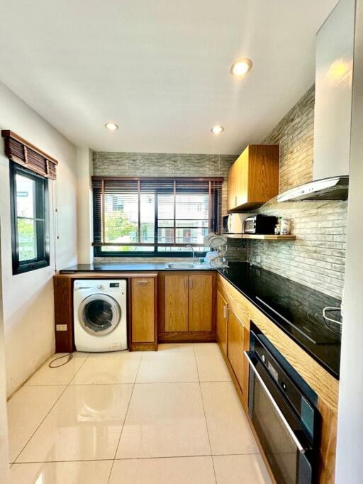 Modern kitchen with wooden cabinets and stainless steel appliances