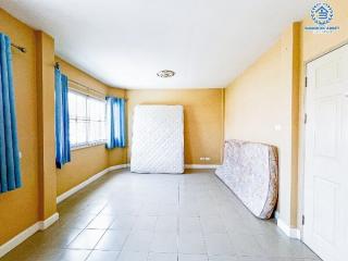 Spacious bedroom with tiled flooring and natural light