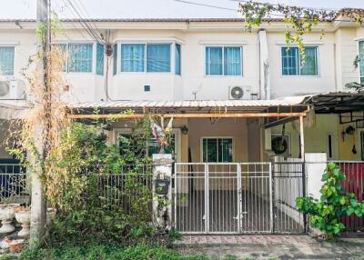 Front view of a two-story townhouse with gated entrance