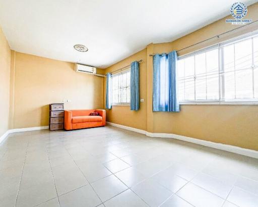 Spacious and well-lit living room area with large windows