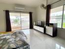 Bright and airy bedroom with large windows and modern amenities