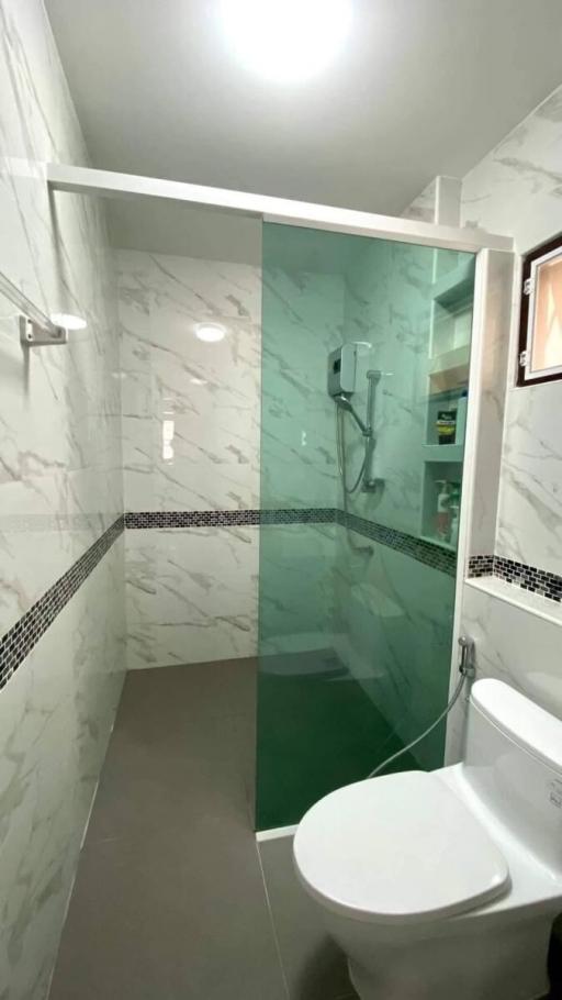 Modern bathroom with glass shower and marble tiles