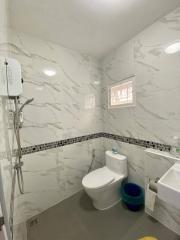 Modern bathroom with marble tiles and essential fittings