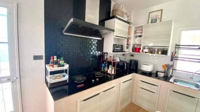 Modern kitchen with white cabinets and dark backsplash