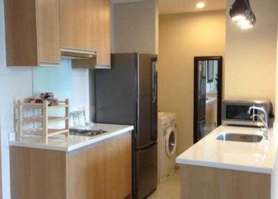 Modern kitchen with stainless steel appliances and wooden cabinetry