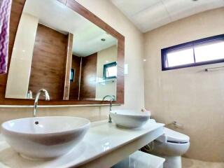 Modern bathroom with double vanity and large mirror