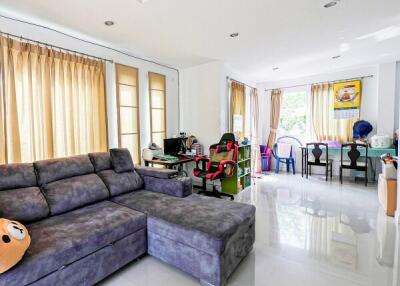 Spacious living room with modern furnishings and abundant natural light