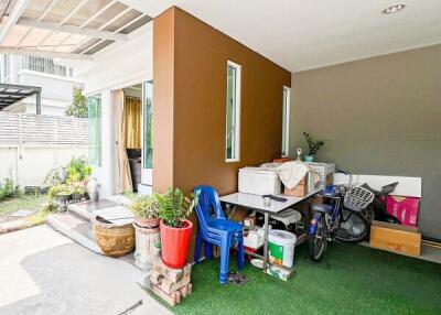 Cluttered patio space with various personal items