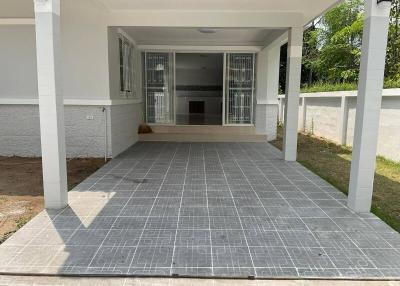 Spacious covered patio with tiled flooring and a fireplace