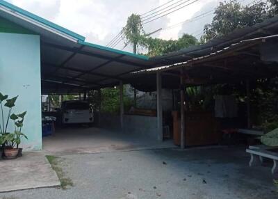 Covered parking area attached to a house