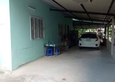 Front view of a house with carport and parked car
