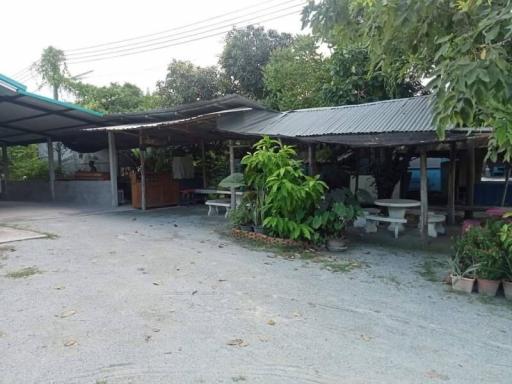 Spacious outdoor area with covered parking and a patio