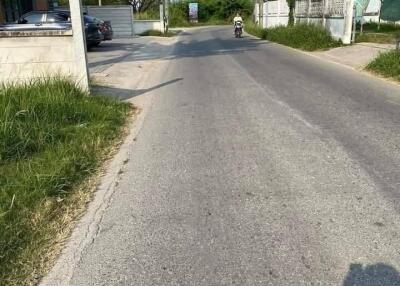 Street view with residential buildings and a motorcycle