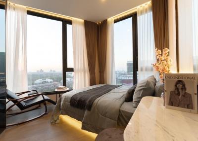 Modern bedroom with large windows and a city view