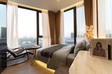 Modern bedroom with large windows and a city view