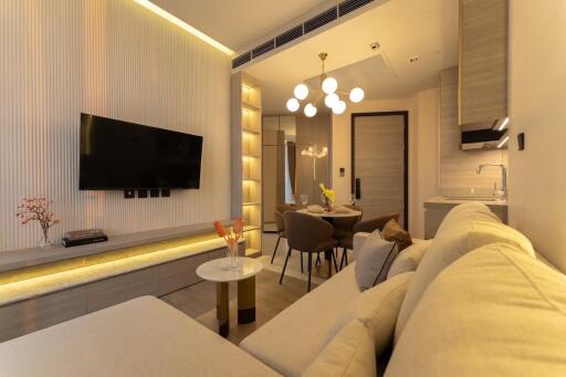 Modern living room interior with comfortable sofa and wall-mounted TV