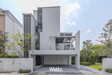 Modern two-story house with a balcony and a carport