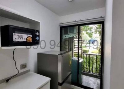 Compact modern kitchen with stainless steel appliances and garden view