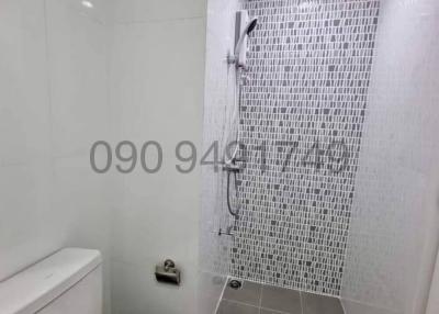Modern bathroom with white tiles and shower