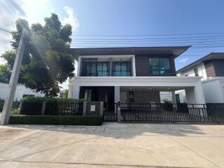 Modern two-story residential home with spacious driveway and exterior