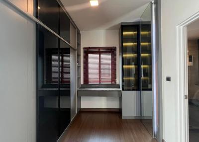 Modern building hallway with wooden flooring and glass walls