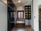 Modern building hallway with wooden flooring and glass walls