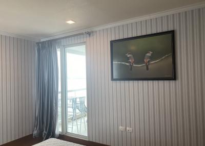 Contemporary bedroom with ocean view and balcony access