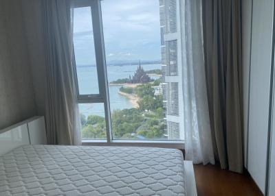 Cozy bedroom with large window overlooking the sea