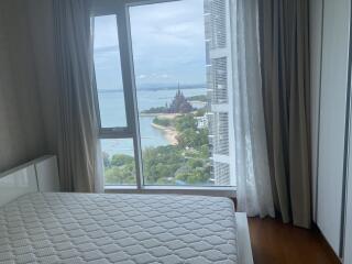 Cozy bedroom with large window overlooking the sea