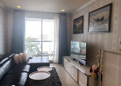 Spacious living room with balcony access and natural lighting