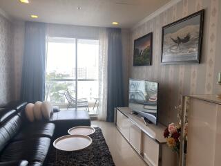 Spacious living room with balcony access and natural lighting