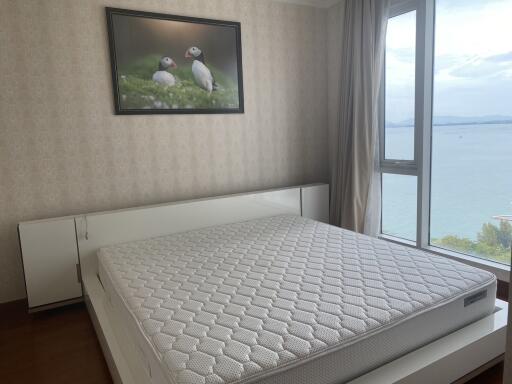 Bright bedroom with a sea view and a large window