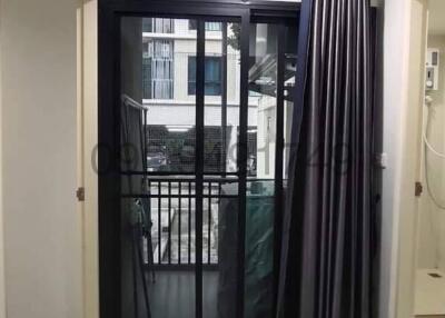 Cozy bedroom with sliding glass door and balcony access