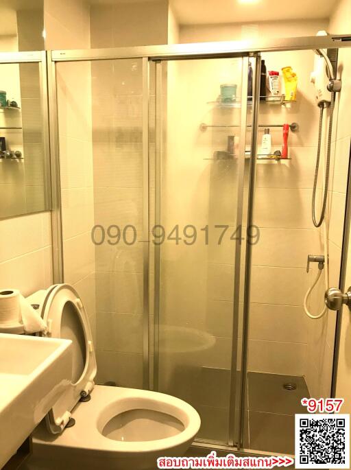 Compact bathroom with shower enclosure and toilet