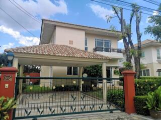 Elegant two-story house with terracotta roof tiles and a covered entrance