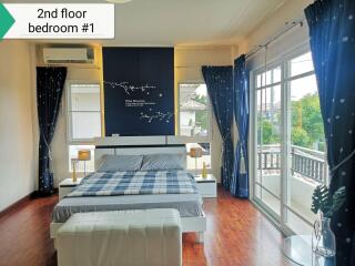 Spacious second floor bedroom with balcony access and natural light